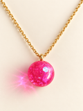 Collier boule rose pailletée en résine fait main en Alsace
